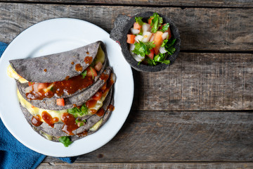 Quesadillas with blue corn tortillas and mexican red sauce
