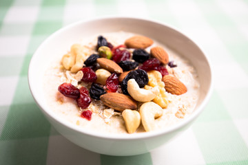 Healthy breakfast fresh granola muesli with milk and nuts