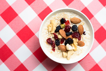 Healthy breakfast fresh granola muesli with milk and nuts