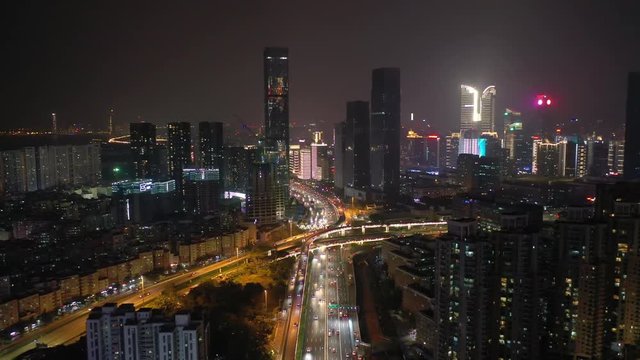 night illumination flight over shenzhen city downtown traffic street aerial panorama 4k china