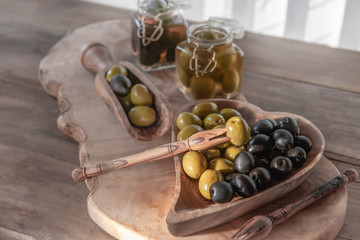 green olives are on the table in a bowl of olive tree. The concept of healthy eating