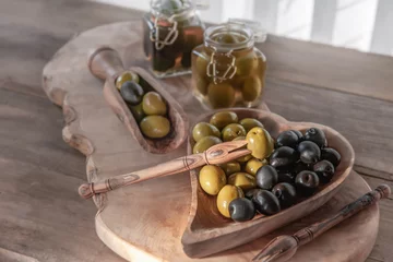 Foto op Plexiglas green olives are on the table in a bowl of olive tree. The concept of healthy eating © oksanamedvedeva