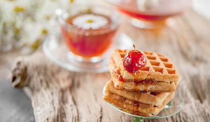 Homemade waffles with Apple jam on a wooden table. Close up.