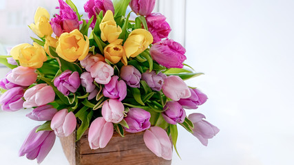 A beautiful bouquet of tulips with a white cup for tea.