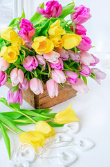 A beautiful bouquet of tulips with a white cup for tea.