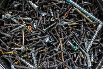 Screws screws and dowels. Background from metal products close up