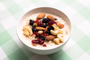 Healthy breakfast fresh granola muesli with milk and nuts