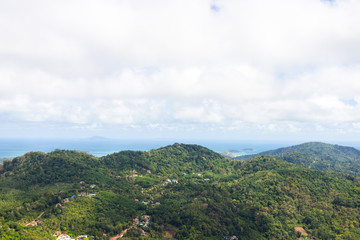 Fototapeta na wymiar mountain scape with some village on there and can see the beach from Phuket island with cloudy sky
