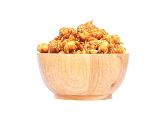 Popcorn with caramel in a wooden bowl isolated on white background with clipping path..
