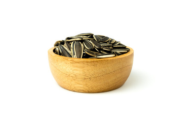 Close up of sunflower seeds in wooden bowl against on white background and clipping path.