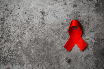 Red ribbon for world aids day awareness campaign background.