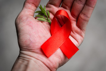 Red ribbon for world aids day awareness campaign background.