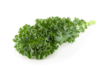 Fototapeta premium Fresh organic green kale leaves isolated over white background