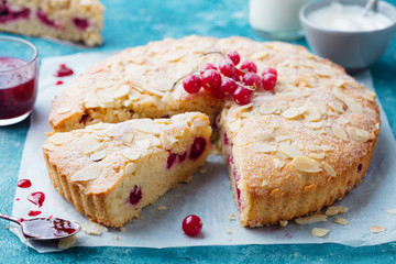 Almond and berry cake, Bakewell tart. Traditional British pastry. Blue background.