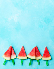 Watermelon slices on blue background. Top view. Copy space.