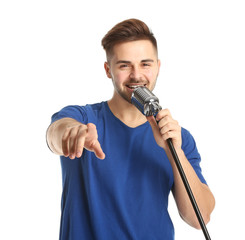 Fototapeta na wymiar Handsome male singer with microphone on white background