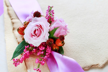 Roses, heather and hawthorn berries in small bouquet