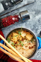 Beef stroganoff with mashed potatoes in a pot. top view, stone background