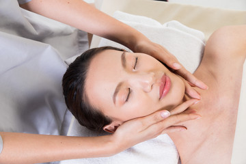 Fototapeta na wymiar Ayurvedic Head Massage Therapy on facial forehead Master Chakra Point of Asian woman, Therapist Spa body woman hands treatment on customer to increase circulation release tension stress of think work