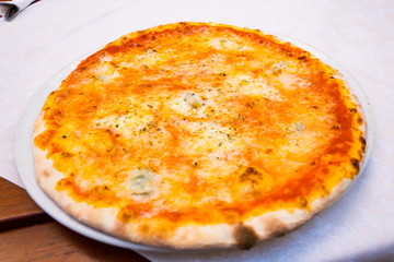 four cheeses pizza on white plate