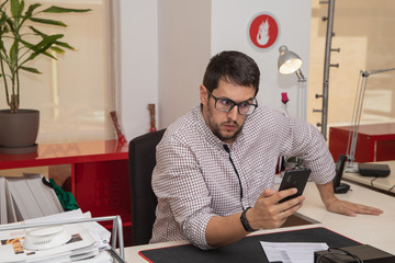 young man using smartphone in the office