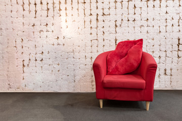 Red sofa with white brickwall