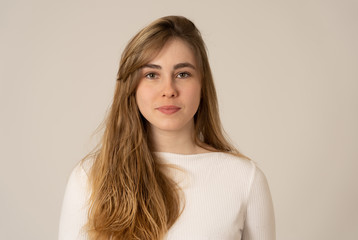 Natural portrait of young attractive teenager woman looking and posing with neutral face expression