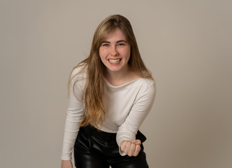 Fototapeta premium Surprised happy teenager girl celebrating victory goal or having lots of followers in social media