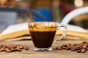 Dark espresso coffee and book