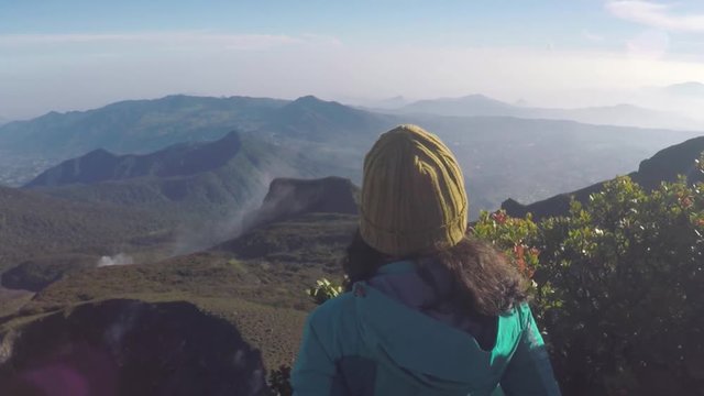 Woman looking at the valley at the peak at Gede Pangrango mountain