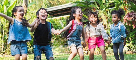 Diversity kids holding hands and playing at outdoor park