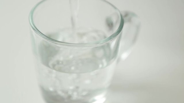 Adding carbonated water and ice. Step-by-step preparation of cocktails in glass.