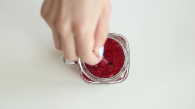 Adding berries and ice to carbonated water. Step by step preparation of cocktails with lemon and orange.