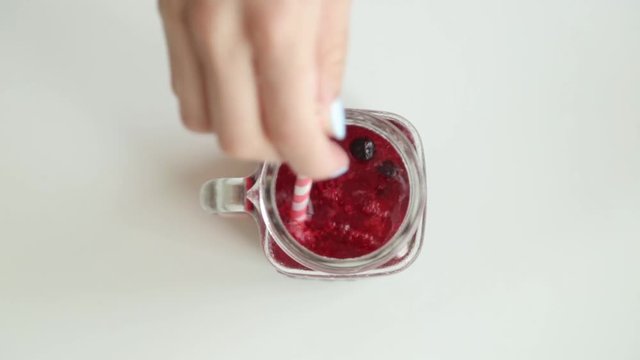 Adding berries and ice to carbonated water. Step by step preparation of cocktails with lemon and orange.