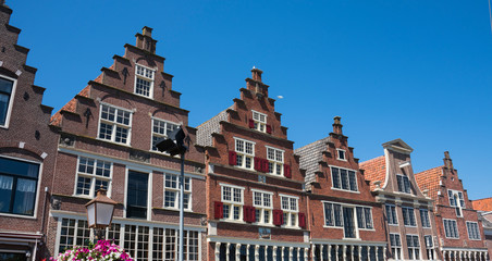 Fototapeta na wymiar typical Dutch houses with stepped gable in Hoorn, The Netherlands