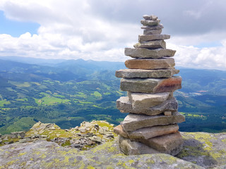 cairn (Inukshuk rocks) at the top of La Rhune mountain in the Atlantic Pyrenees. Border between Spain and France.