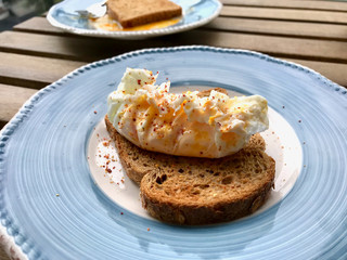 Poached Egg with Spices on Toast Bread for Breakfast.