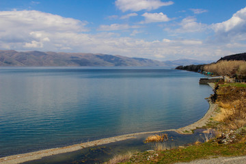 Lake Sevan is the largest body of water in Armenia and in the Caucasus region. Blue expanses of water and mountains. Natural Ecological Background