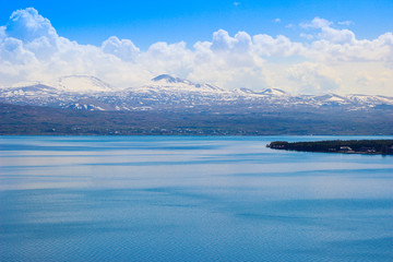 Lake Sevan is the largest body of water in Armenia and in the Caucasus region. Blue expanses of water and mountains. Natural Ecological Background