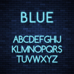 Obraz premium Glowing neon alphabet on brick wall background