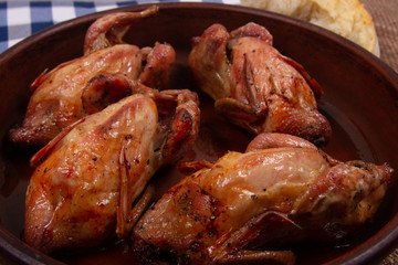 Roasted tiny chicken  with Golden brown crispy crust. Close-up.
