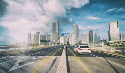 Fototapeta na wymiar Entering Miami on the road with a beautiful city skyline, Florida, USA