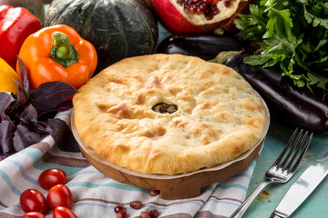 Traditional oriental cuisine Meat pie and fresh vegetables on textile napkin
