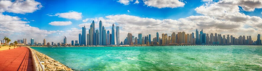 Fototapeta na wymiar DUBAI, UAE - DECEMBER 10, 2016: .View of Marina buildings from Palm Jumeirah. Dubai attracts 15 million tourists annually