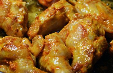 Close up of fried juicy hot chicken wings.