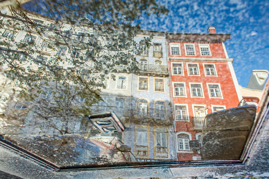 reflection in the puddlу of an old building