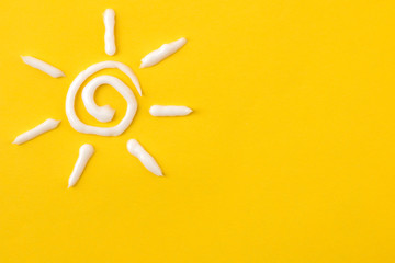 Sun from cream on bright pink background. Sun protection concept. Ultraviolet protection. Summer....