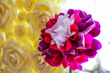 wedding photo zone made of artificial paper in the form of red and yellow roses