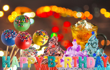 birthday greetings on delicious cakes and candy background