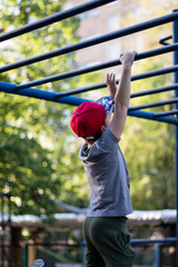 young boy doing workout outdoors at the playground